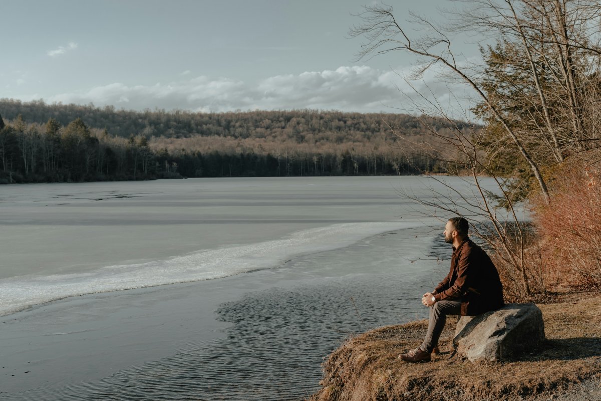 partner sitting looking across a lake